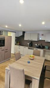 a kitchen with a large wooden table with chairs at Moni's Ferienwohnung in Hammelburg