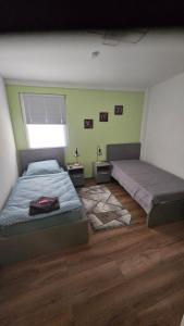 a bedroom with two beds and a window at Moni's Ferienwohnung in Hammelburg