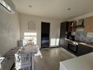 a kitchen with a table and chairs in a room at "Chambre" Chez Zabou in Carpentras +1 photo