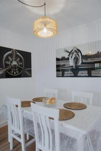 a dining room with a white table and chairs at El Hierro Bed in Valverde