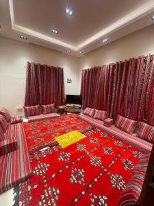 a large room with red curtains and a red carpet at House of Nomads - Hostel in Muscat +20 photos