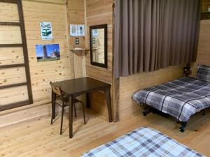 a room with two beds and a desk in a cabin at Guesthouse Coco Garage in Kirishima +97 photos