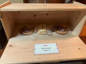 a wooden box with three loaves of bread at Guesthouse Coco Garage in Kirishima