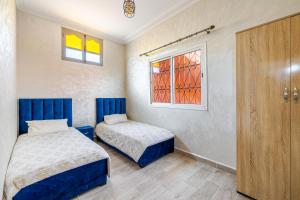 a bedroom with two beds and a window at Private Villa with Pool and Hammam Marrakech in Oulad Akkou +25 photos