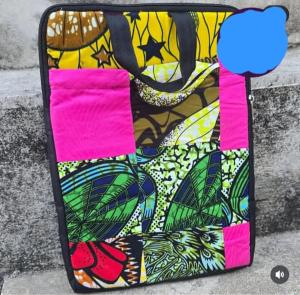 a bag sitting on the ground next to a wall at Mabegi african Designs in Arusha