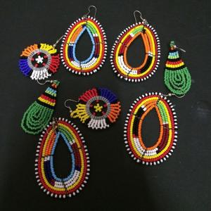 a group ofadedadedadedaded earrings on a black background at Mabegi african Designs in Arusha