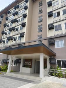 an apartment building with an aor sign in front of it at JB Casa del Alivio in Butuan