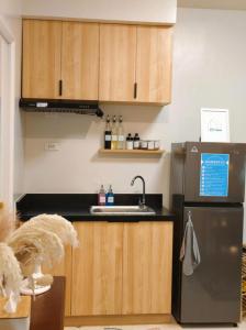 a kitchen with a sink and a refrigerator at JB Casa del Alivio in Butuan