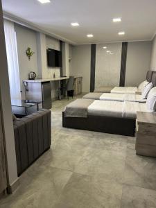 a hotel room with two beds and a desk at Aparan Hotel in Aparan