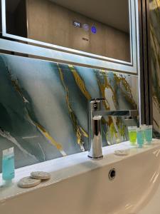 a sink with a faucet in a bathroom at Aparan Hotel in Aparan +44 photos