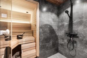 a bathroom with a walk in shower and a shower stall at Bimmel Arctic Suite by PolarVillas in Kittilä +25 photos