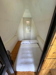 a small room with two beds in a attic at Serenity Cove Resort in San Pablo +34 photos