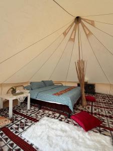 a bedroom with a bed in a tent at Stars Dunes Private Camp in Badīyah