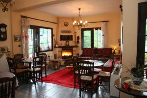 a living room with a table and chairs and a fireplace at Xenonas Agnanti in Neraidochori