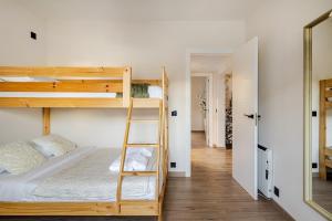 a bedroom with two bunk beds and a ladder at O Lar de Laura Casa familiar para escapada tranquila con piscina y sala de juegos cerca de Vigo in Vigo +31 photos