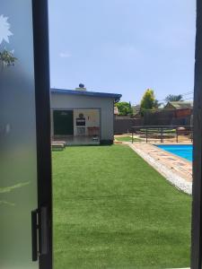 a view of a building with green grass at Palma Royal Ensuite in Pretoria