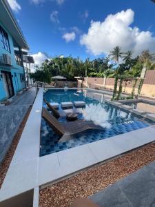 a swimming pool with a bench and a table at Gavins Nest in Romblon