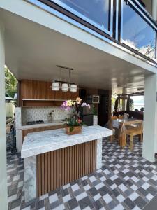 a kitchen with a counter and a dining room at Gavins Nest in Romblon