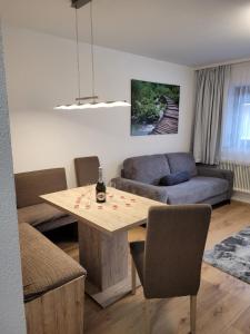 a living room with a table and a couch at Apartament Zaharia Ötztal in Tumpen