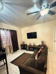 a living room with a couch and a ceiling fan at Escape to paradise in Providenciales