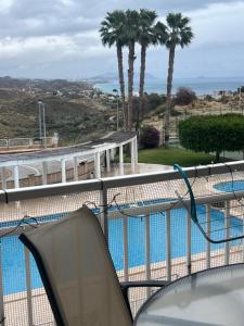 a balcony with a view of a swimming pool at Bel appartement in Alicante
