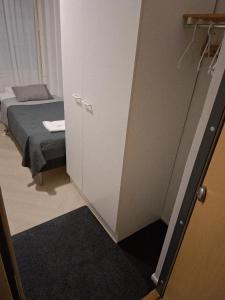 a small room with a bed and a closet at Centrum Apartment Kokkola in Kokkola