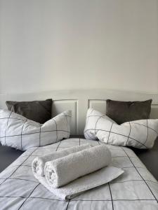 a white bed with two pillows on top of it at Kiadó apartman in Borsec