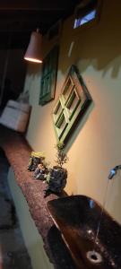 a bathroom with a sink and a window on the wall at Bituca Hostel e Café in Milho Verde