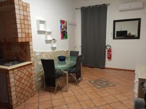 a dining room with a glass table and chairs at Fabian Appartament in Bagheria