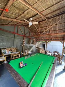 a pool table in a room with a ceiling at Serenity Cove Resort in San Pablo