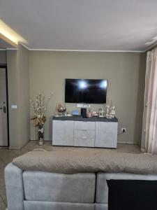 a living room with a flat screen tv on a wall at House Barbanera in Spello