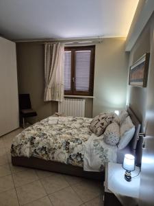 a bedroom with a bed and a window at House Barbanera in Spello +26 photos