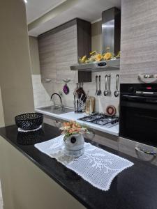 a kitchen with a counter with a sink and a stove at House Barbanera in Spello