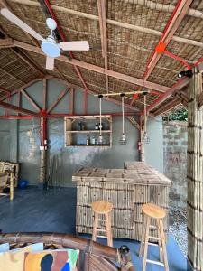 a room with two stools and a ceiling fan at Serenity Cove Resort in San Pablo