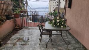 a table with flowers on it on a patio at KositasRikas B&B in Viña del Mar