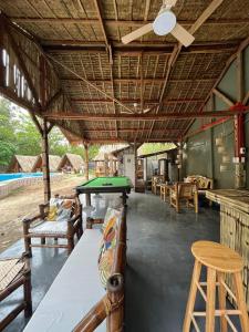 a room with a ping pong table and chairs at Serenity Cove Resort in San Pablo