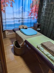 a room with two beds in a room with a window at Guest house AIZU First in Aizuwakamatsu +21 photos