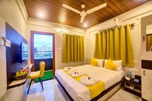 a bedroom with a bed with yellow curtains and a window at Hotel Airline Inn - Near Kempegowda International Airport in Muthugadahalli