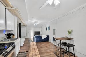 a kitchen and living room with white walls and a table at Cozy Baltimore Studio apts in Baltimore