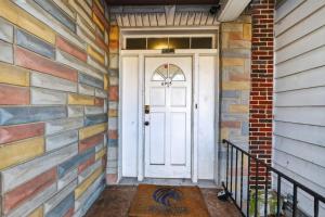 a front door of a house with a brick wall at Cozy Baltimore Studio apts in Baltimore