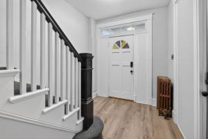 a hallway with stairs and a door with a window at Cozy Baltimore Studio apts in Baltimore