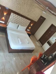 a bedroom with a white bed and a mirror at Imperial Hotel Near Haji Ali in Mumbai +32 photos