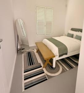a small bedroom with a bed and a stairwell at Crescent House in Franschhoek