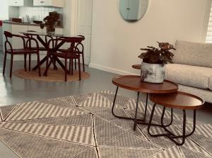 a living room with a table and a couch at Crescent House in Franschhoek +16 photos