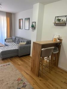 a living room with a couch and a table at Apartman MAD Bjelasnica in Bjelašnica