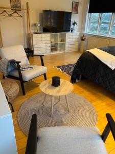 a living room with a table with a hat on it at Kilimanjaro & Stayover in Svinninge