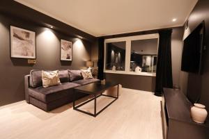 a living room with a couch and a table at Arctic City Suites 1 in Kirkenes