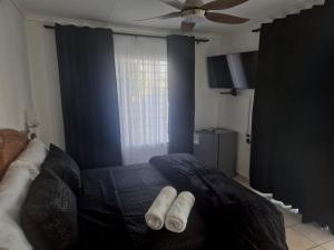 a bedroom with a bed with two white socks on it at 31 on Queen in Margate