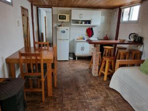a kitchen and dining room with a table and a refrigerator at Los Nietos in La Paloma