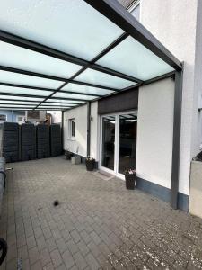 a patio with awning on the side of a building at Ferienwohnung im Hasenwieschen in Kaisersesch